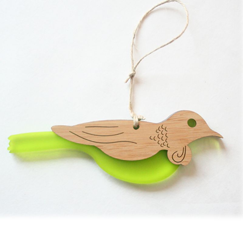 Elegant Tui hanging ornament made of bamboo and lime green satin acrylic, featuring intricate laser-cut designs.