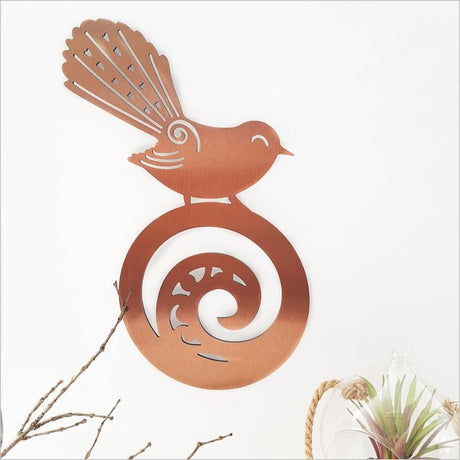 Brushed copper wall art of a Fantail on a Koru, symbolizing nature and culture, perfect for any decor.