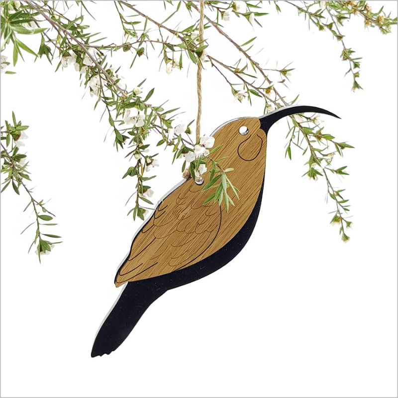 Elegant Huia hanging ornament crafted from bamboo and satin black acrylic, ideal for holiday decor and gifting.