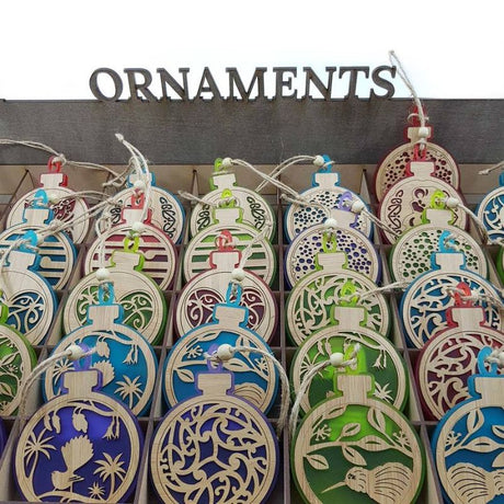 Red satin acrylic hanging ornament featuring a Koru design, perfect for festive decor and year-round display.