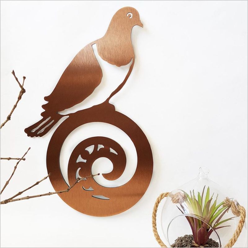 Brushed copper wall art featuring a Kereru on Koru design, ideal for enhancing indoor or outdoor spaces.