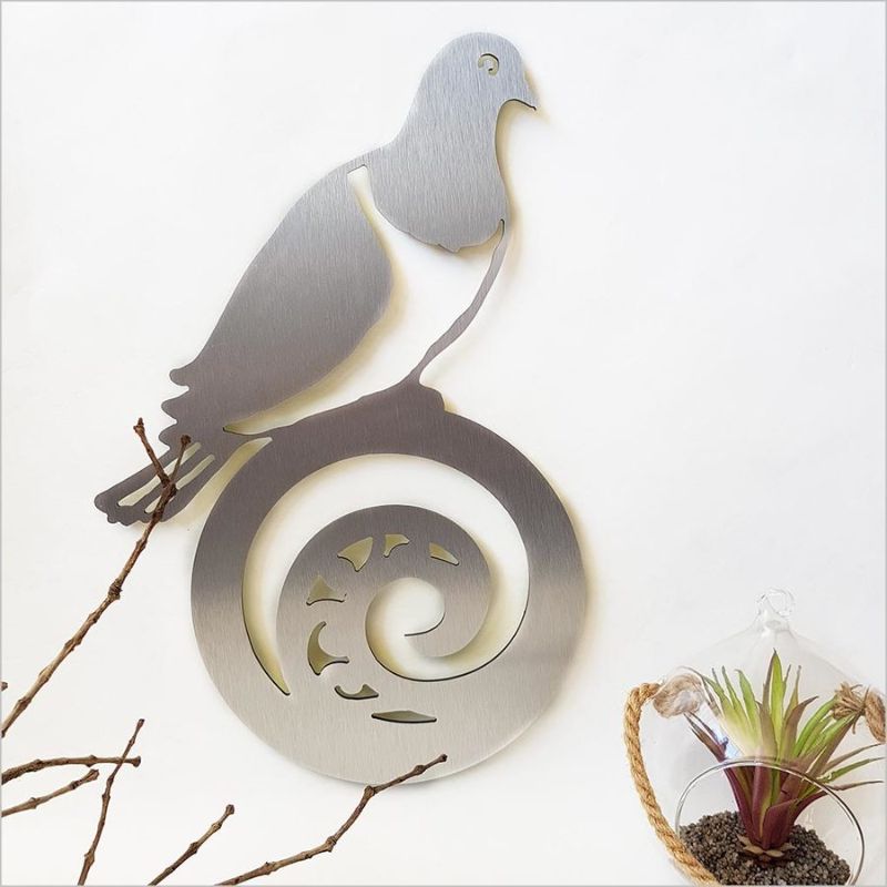Elegant wall art featuring a Kereru on Koru, crafted from brushed silver ACM, perfect for indoor and outdoor decor.