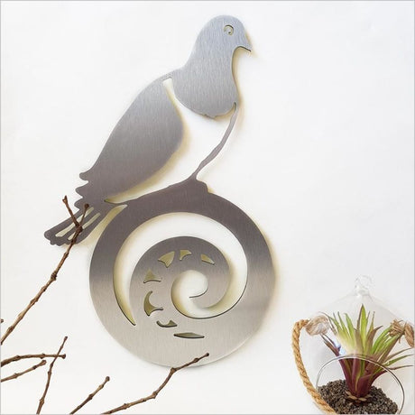 Elegant wall art featuring a Kereru on Koru, crafted from brushed silver ACM, perfect for indoor and outdoor decor.