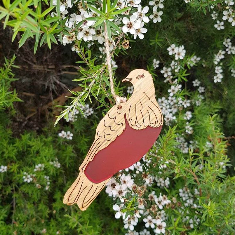 Elegant hanging ornament featuring a laser cut kereru in bamboo and vibrant red satin acrylic, perfect for home decor.