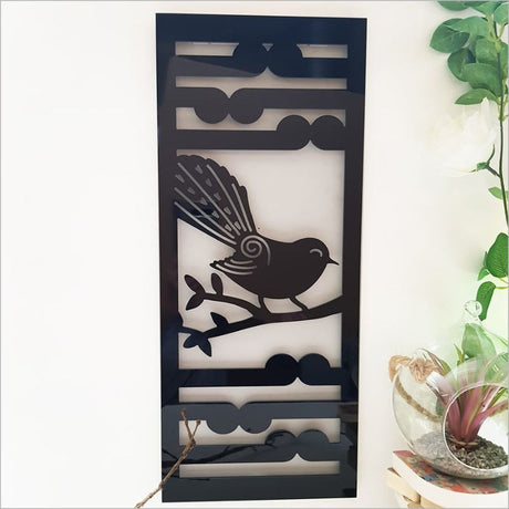 Elegant black wall art panel featuring Fantail and Koru motifs, ideal for indoor and outdoor decor, 55cm high.
