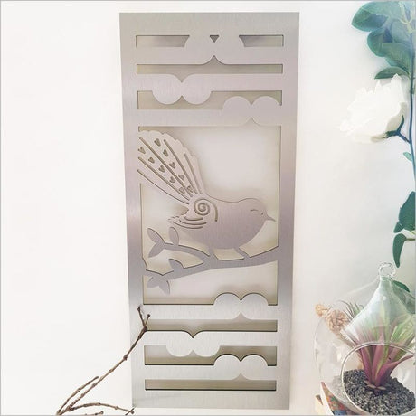 Brushed silver ACM wall art panel featuring nature-inspired fantail and koru designs, ideal for indoor and outdoor use.