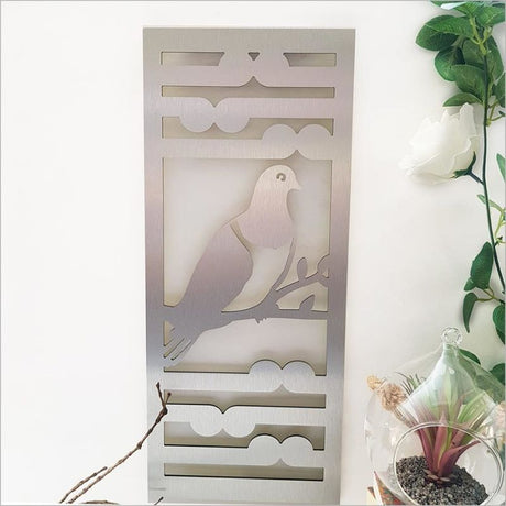 Brushed silver wall art panel featuring a kereru and koru design, perfect for indoor or outdoor decor.
