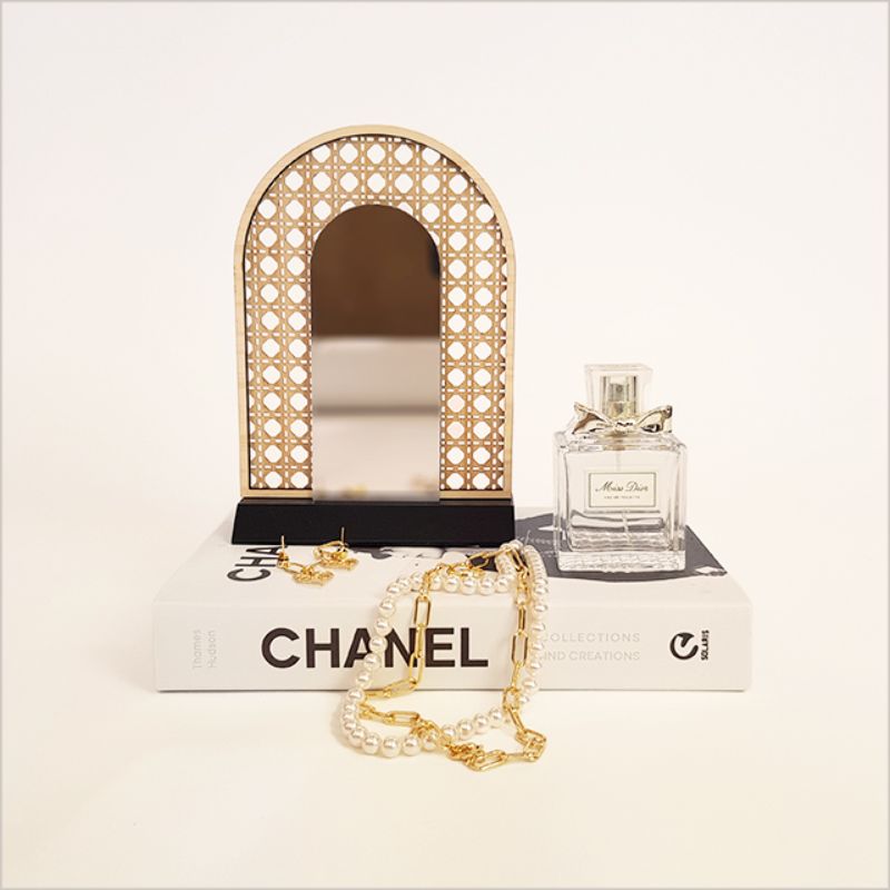 Elegant rattan earring stand with mirror, perfect for showcasing and organizing earrings on any dresser.
