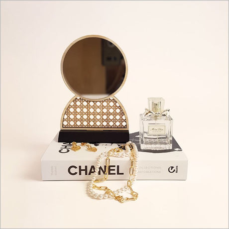 Elegant rattan earring stand with built-in mirror, perfect for jewelry display and organization, handmade from natural materials.