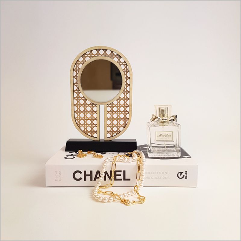 Elegant rattan-inspired earring stand with mirror, ideal for organizing and displaying jewelry in style.