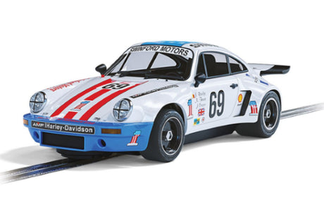 Porsche 911 Carrera RSR slot car in USA-themed livery, celebrating its 1975 Le Mans performance with intricate detailing.