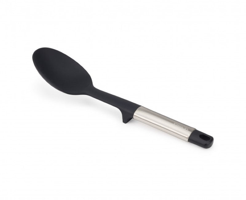 Joseph Joseph Elevate Silicone Solid Spoon with heat-resistant head and stainless-steel handle for mess-free cooking.
