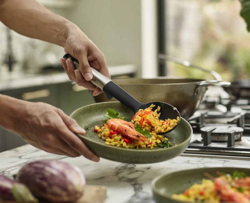 Joseph Joseph Elevate Silicone Solid Spoon with heat-resistant head and stainless steel handle, ideal for mess-free cooking.