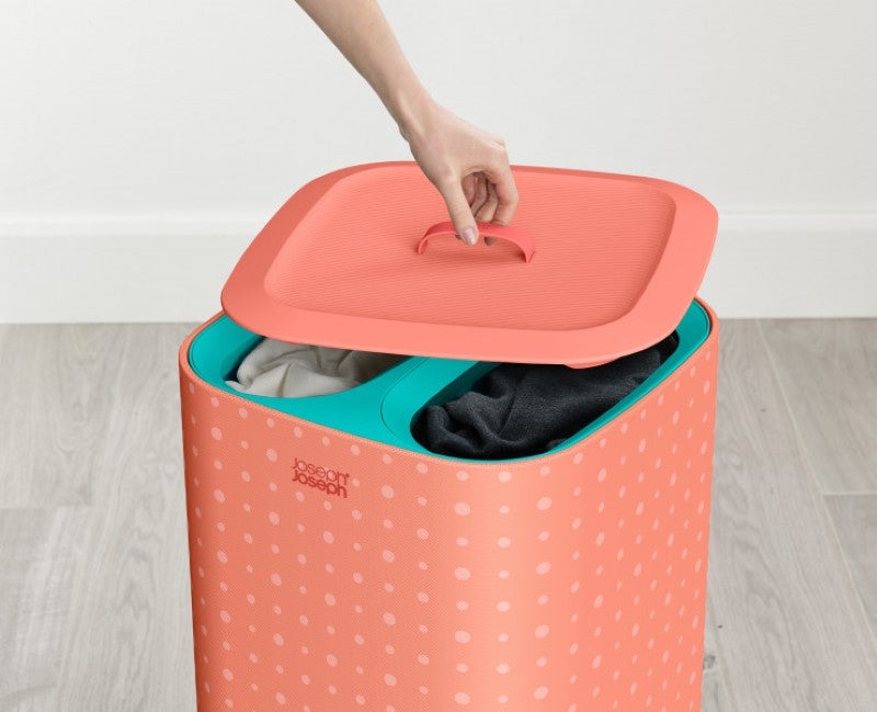 Joseph Joseph Tota Pop 60L laundry basket in coral with tri-bag system for easy sorting of light, dark, and colored fabrics.