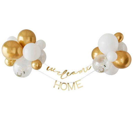 Gold and white balloon backdrop kit with 'Welcome' and 'Home' bunting for baby celebrations.