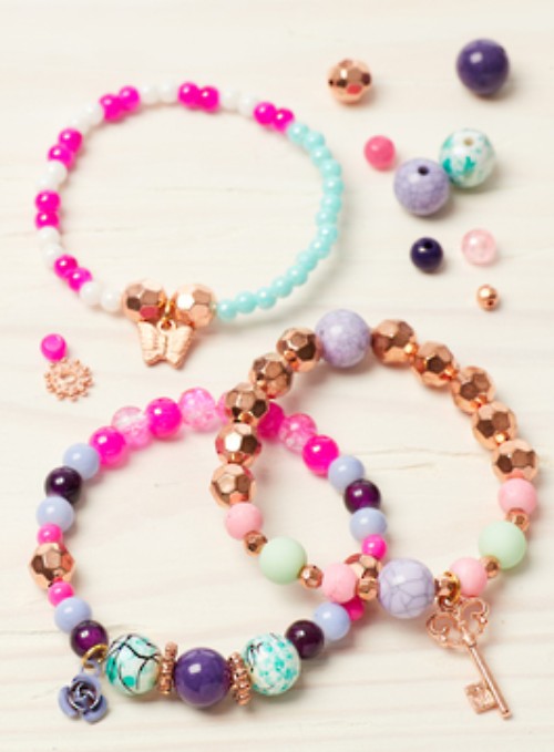 DIY charm bracelet kit with vibrant beads, playful charms, and matching tattoos for creative fun.