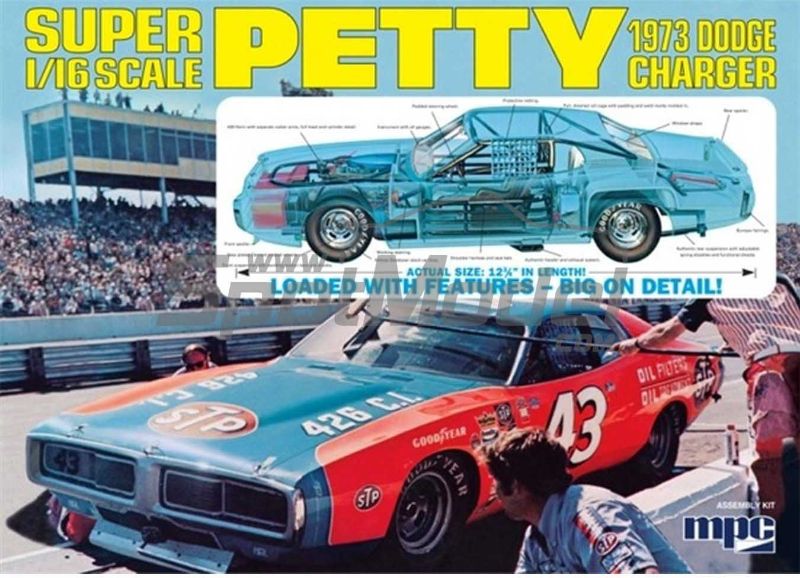 Detailed 1/16 scale model kit of the 1973 Dodge Charger, featuring working mechanisms and clear engine parts.
