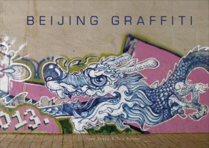 Hardback book titled 'Beijing Graffiti' showcasing vibrant urban art, featuring photos by Tom Dartnell and artist interviews.