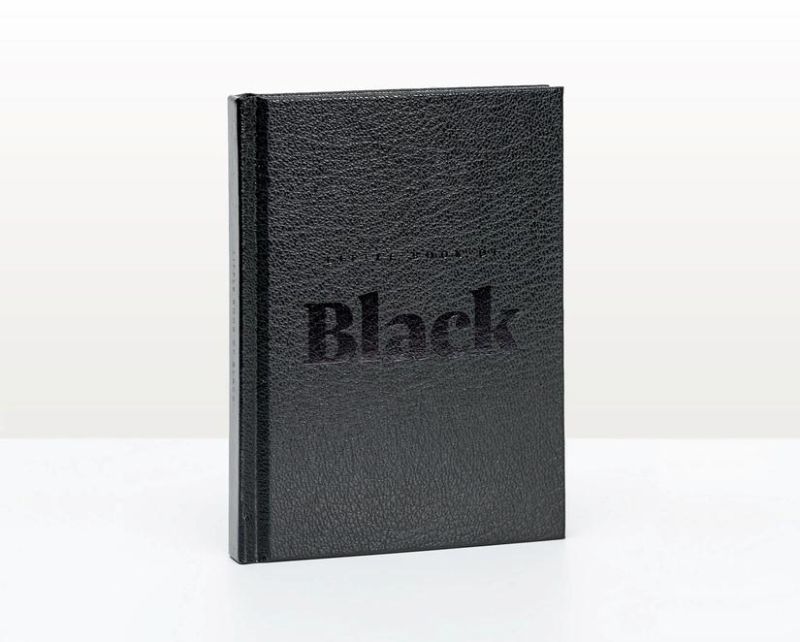 Hardback book 'Little Book Of Black' featuring artwork on the theme of black, with a leather-look cover and black ribbon.