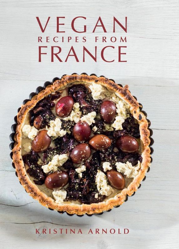 Hardback cookbook featuring colorful vegan French dishes, including baguettes, desserts, and classic recipes by Kristina Arnold.