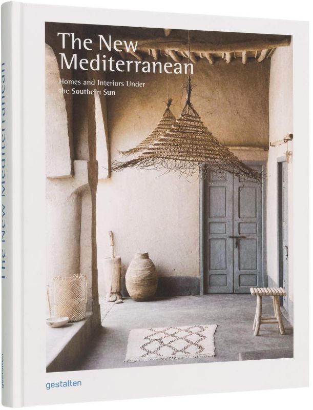 Hardback book showcasing Mediterranean-inspired home decor featuring earthy tones and minimalist design elements.