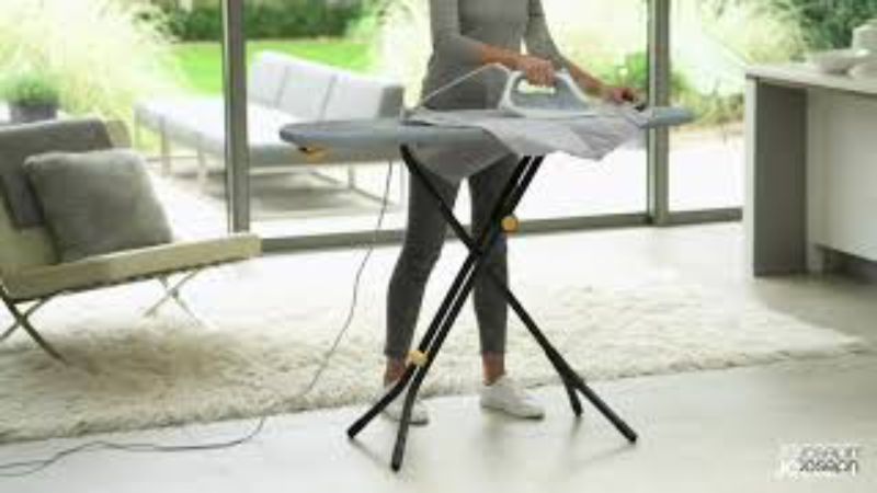 Joseph Joseph Glide Plus ironing board in Black/Blue, featuring compact storage, adjustable height, and heat-resistant iron rest.