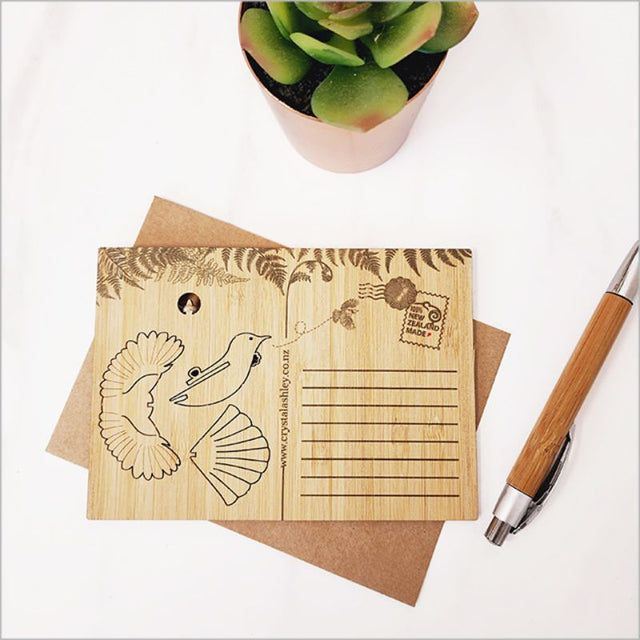 Bamboo postcard featuring Tui bird design, transforms into a 3D ornament, eco-friendly and perfect for messages.
