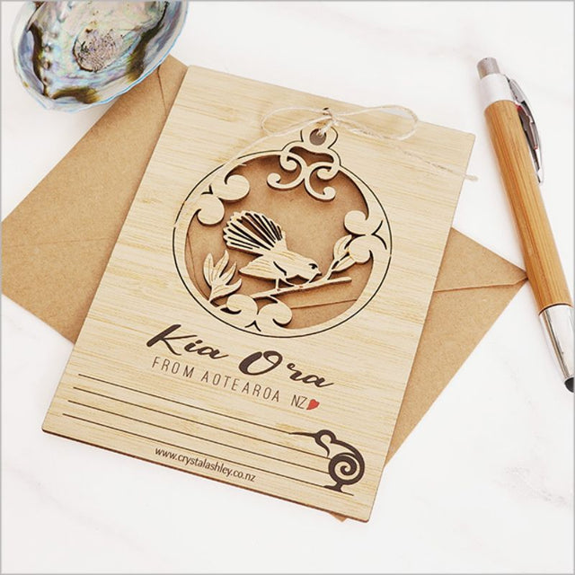 Eco-friendly bamboo postcard featuring intricate fantail motifs, perfect for greetings or decorative displays.