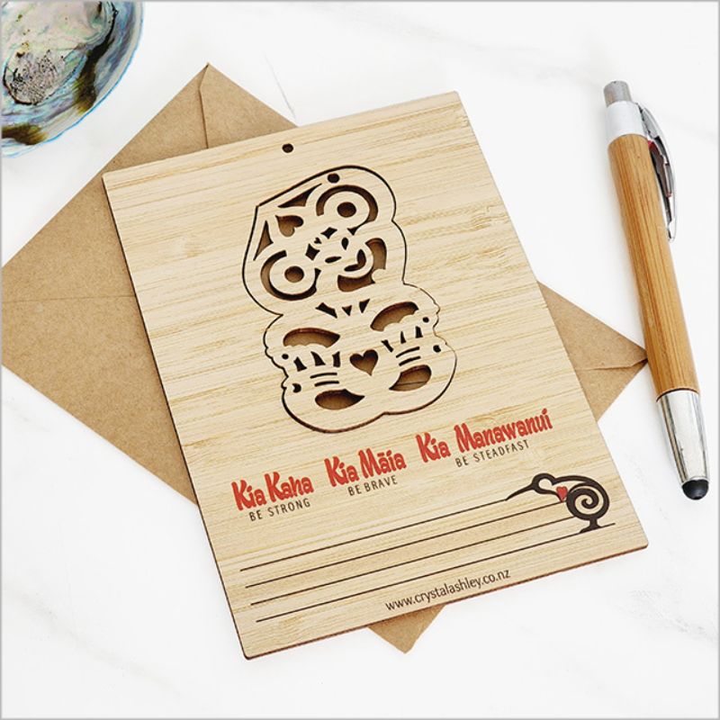 Eco-friendly bamboo postcard featuring vibrant Tiki design, comes with jute string and craft envelope for unique greetings.