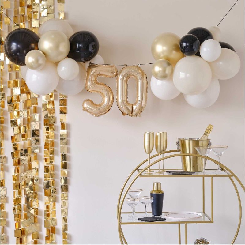 Elegant champagne noir balloon bunting for 50th birthday celebrations, perfect for indoor or outdoor decor.