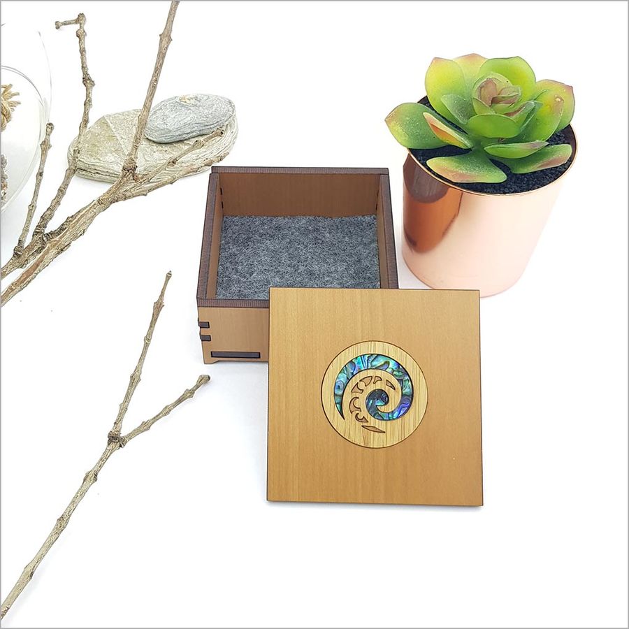 Small Koru trinket box in NZ veneer with vibrant paua inlay, perfect for jewelry and small treasures.