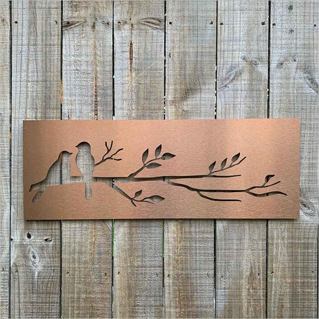 Brushed copper wall art featuring birds on a branch, perfect for enhancing indoor or outdoor spaces.