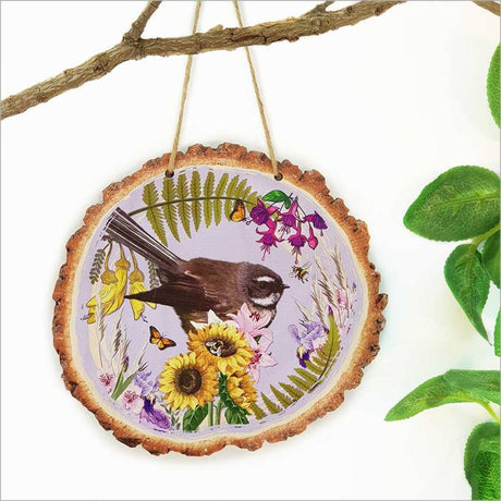 Wood slice wall art featuring a colorful NZ Fantail bird, perfect for nature-inspired home decor.