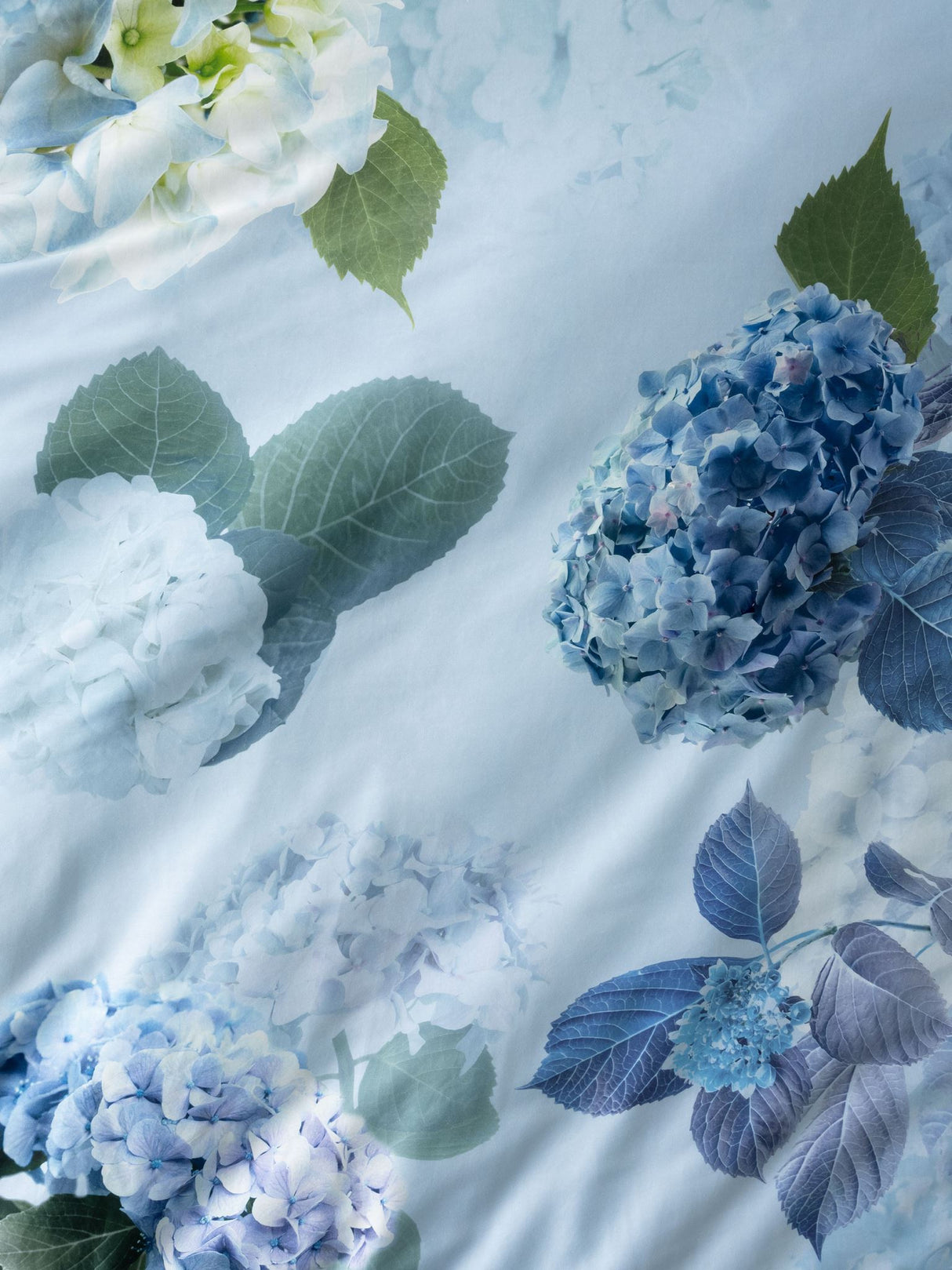 Thea Duvet Cover Set by Savona in sage, featuring a floral design with hydrangeas on soft cotton for queen beds.