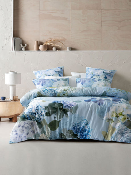 Thea Duvet Cover Set by Savona in sage features hydrangea blooms on soft cotton, perfect for a serene Queen-sized bedroom.