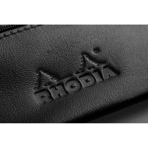 Elegant black leather pencil case with metallic puller and embossed Rhodia logo, perfect for organizing writing supplies.