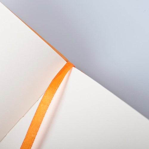 Rhodia Webnotebook A4 in vibrant orange with Italian leatherette cover and 192 blank, bleed-proof pages for creative writing.