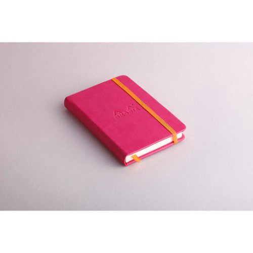 Rhodiarama pocket notebook in vibrant raspberry with hard cover, 192 lined ivory pages, and elastic closure.