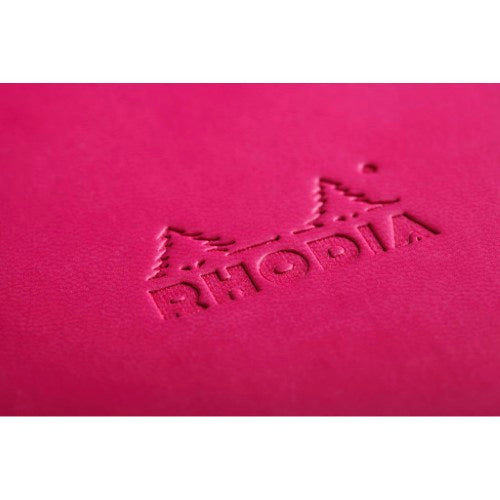 Rhodiarama A5 notebook in raspberry with embossed logo, orange elastic closure, and 192 lined pages for smooth writing.