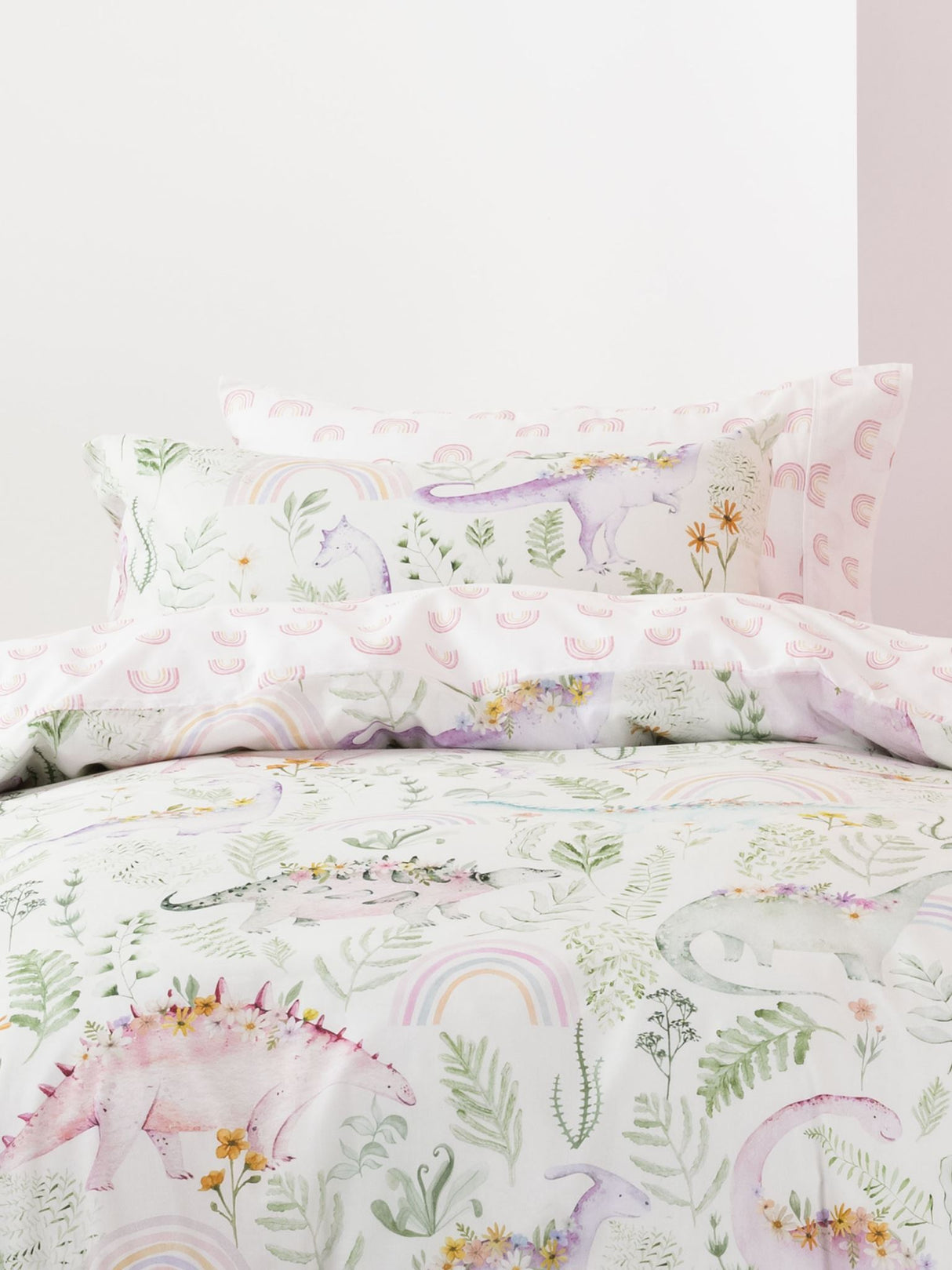 Dino Garden duvet cover set featuring pastel dinosaurs and vibrant blooms, made from soft 100% cotton, perfect for kids' rooms.