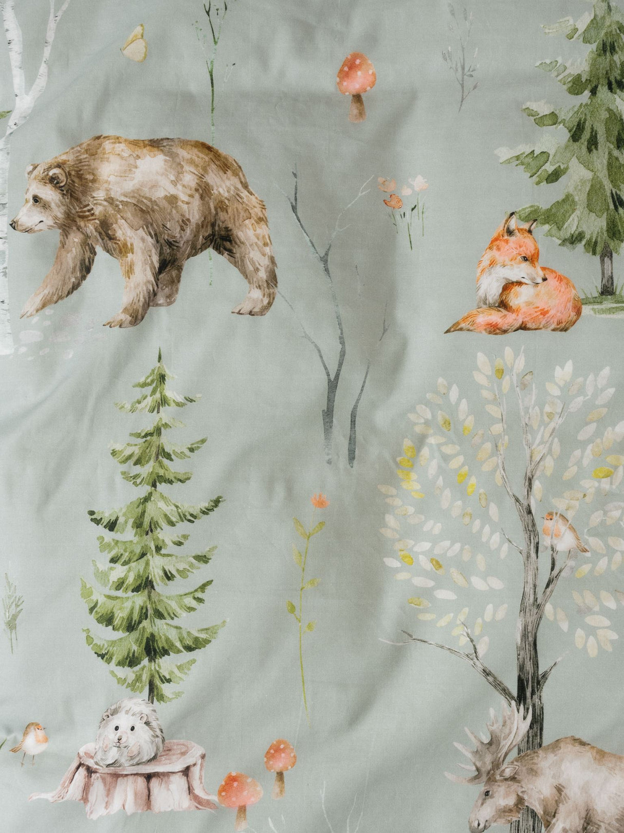 Single duvet cover set featuring magical forest animals on sage green cotton, includes matching taupe pillowcase.