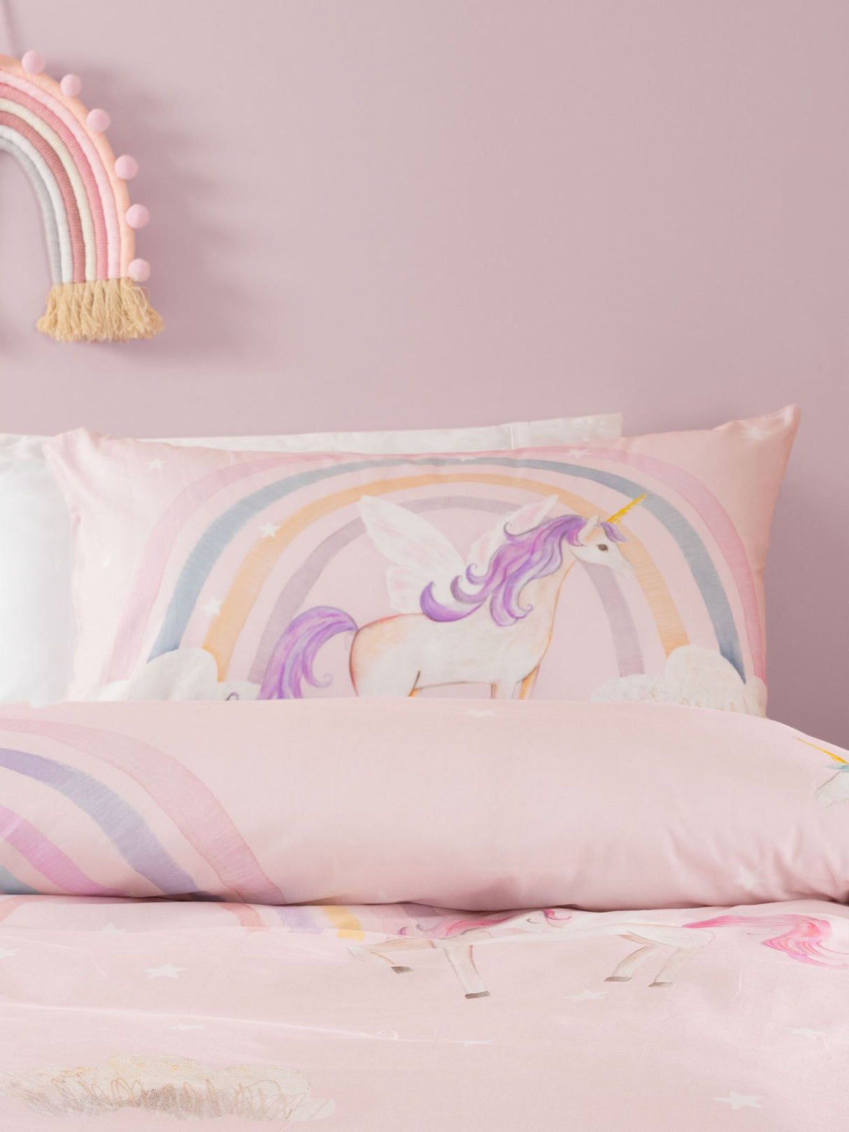 Single duvet cover set featuring whimsical unicorns, rainbows, and stars on a pink background, crafted from 100% cotton.