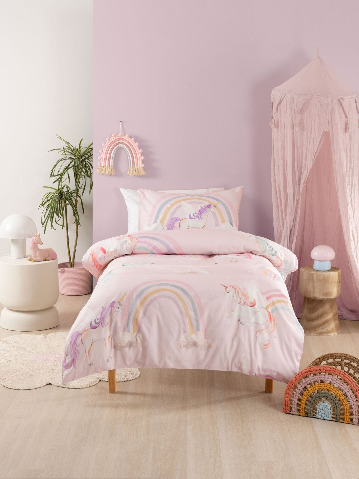 Single duvet cover set featuring whimsical unicorns, rainbows, and clouds on a pink background, crafted from 100% cotton.