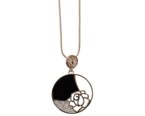 Jax Art Deco Lotus Necklace featuring a rose gold pendant with black and white shell accents and sparkling crystals.