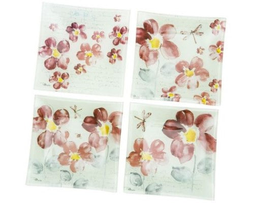 Set of four 15 cm square glass nibbles plates featuring an elegant floral design for serving snacks or organizing small items.