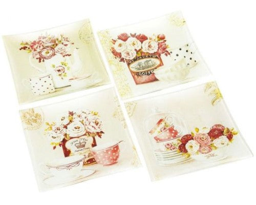 Set of four elegant glass plates with floral designs, perfect for serving nibbles or organizing small items.