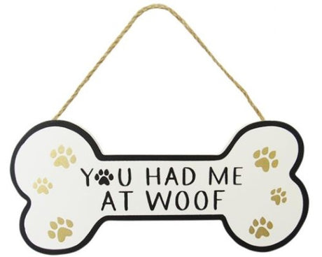Dog bone-shaped wall art with twine hanger, featuring paw prints and 'You had me at woof' for dog lovers.