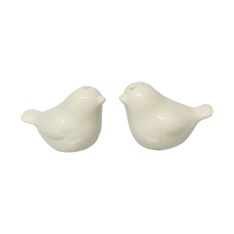 Charming white love bird salt and pepper shakers, perfect for romantic dining and stylish kitchen decor.