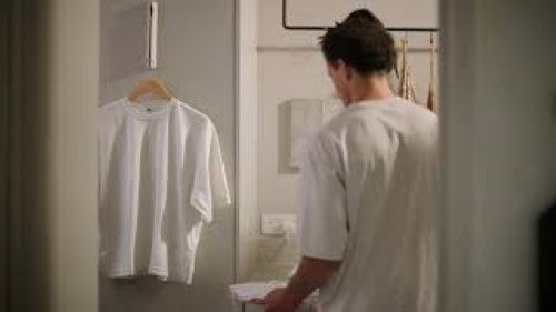 Orderly Retractable Hanging Rail by Joseph Joseph, a space-saving solution for drying and ironing clothes on any wall or door.