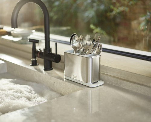 Stainless steel cutlery drainer with divided compartments for organized drying and integrated spout for water drainage.